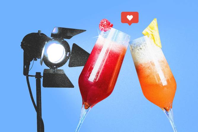 Spotlight on two mocktail drinks clinking together.