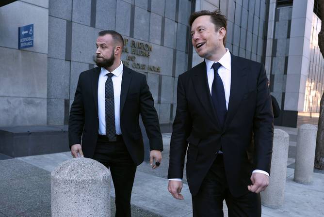 Tesla CEO Elon Musk (R) leaves the Phillip Burton Federal Building on January 24, 2023 in San Francisco, California.