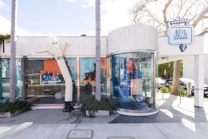 a white inflatable man outside of the Béis Wash, for customers to wash Béis luggage, in LA 