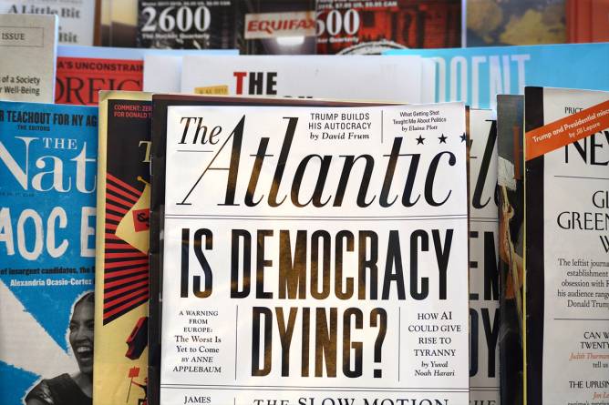 A magazine rack with The Atlantic at the front