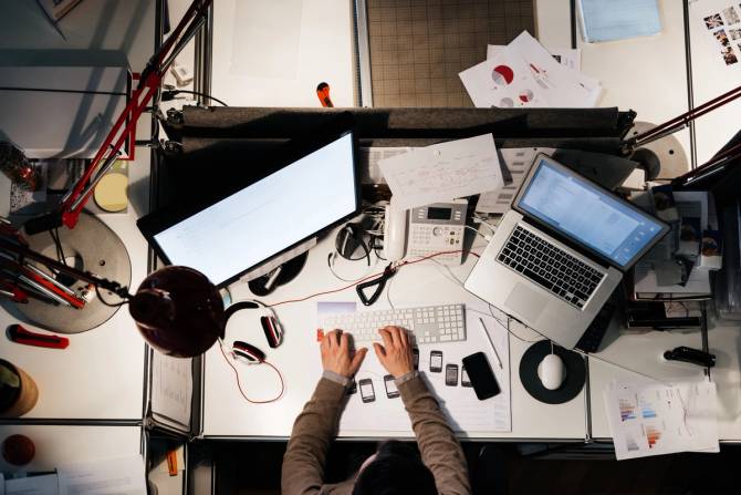 Working at messy desk late at night 