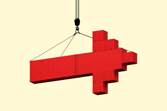 An arrow made of shipping containers hanging from a crane