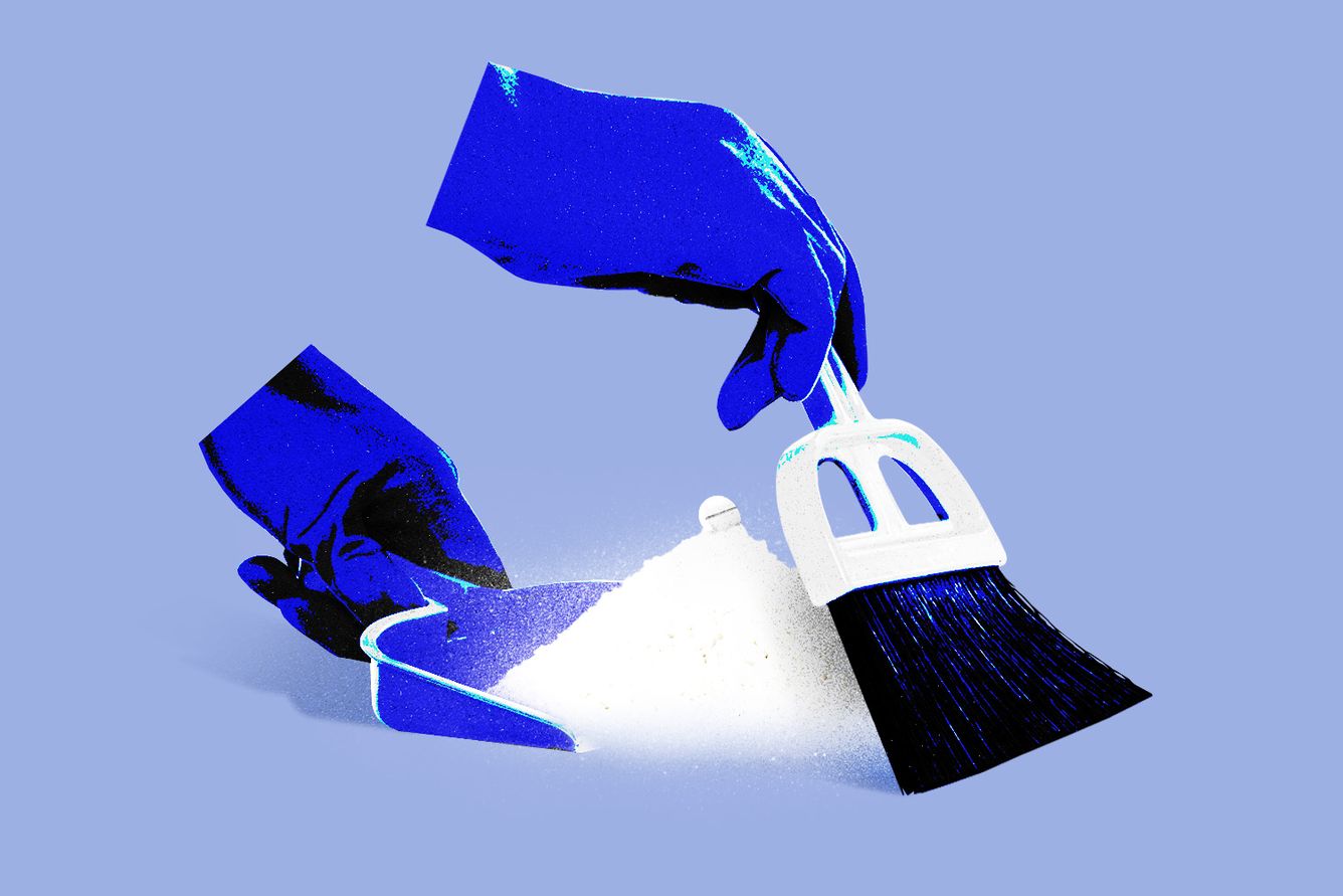 Hands sweeping simufilam into dust pan.