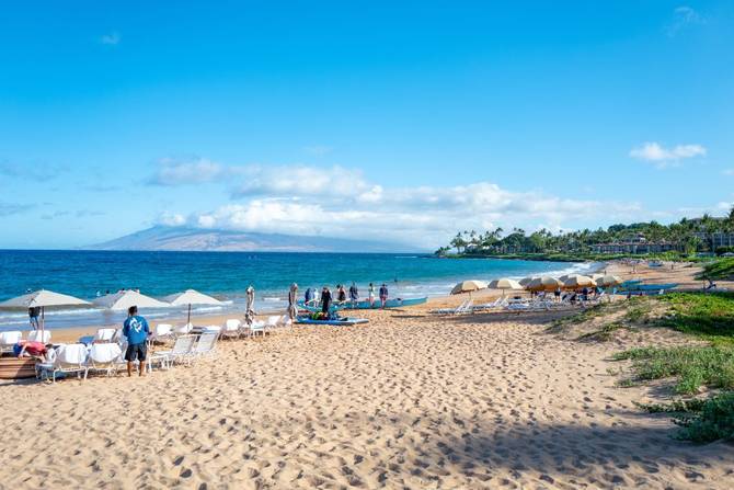 A stretch of Wailea Beach and the Pacific Ocean are visible in front of the Four Seasons Resort Maui at Wailea in Wailea, Hawaii