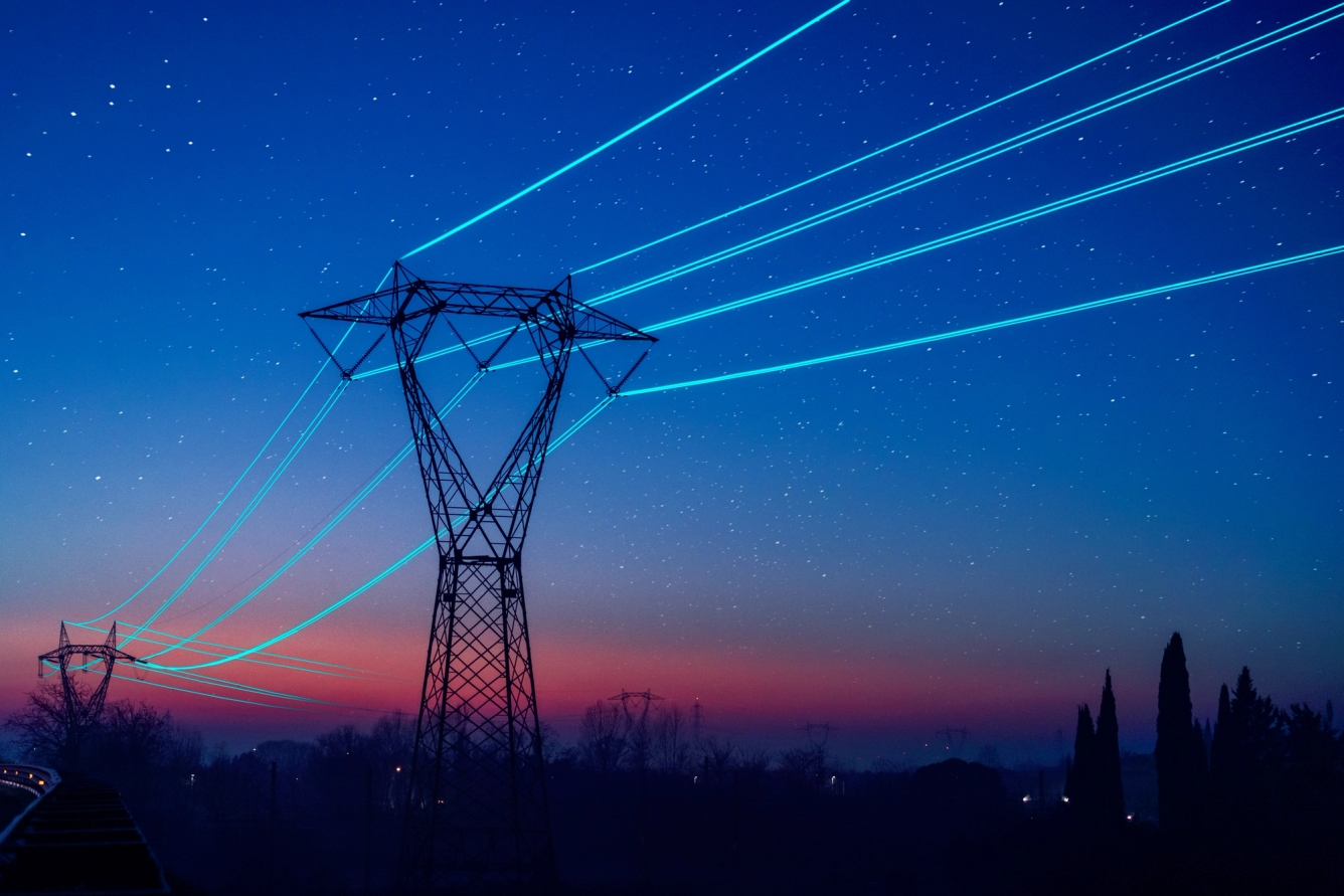 Image of an electricity pilon at night.