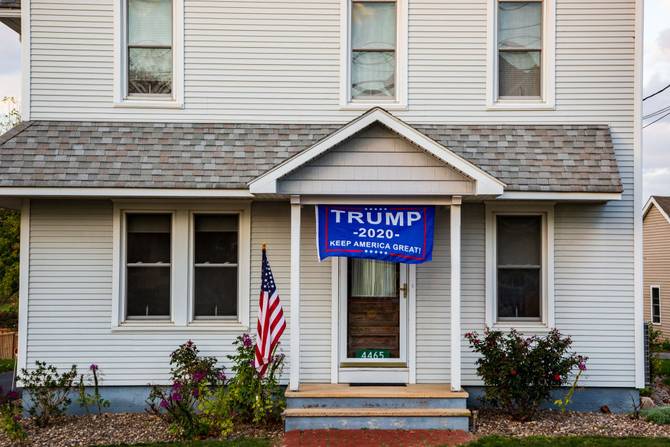 A Trump 2020 flag hangs on the front of a house in the village of Potts Grove, Pennsylvania