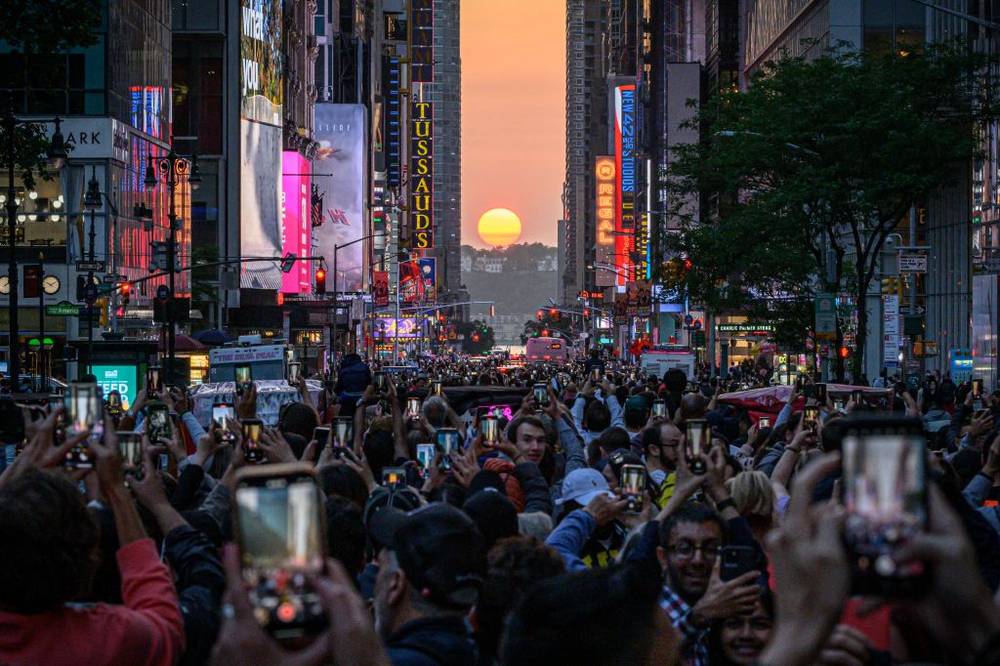 The Sun sets in alignment with Manhattan streets running east-west, also known as Manhattanhenge