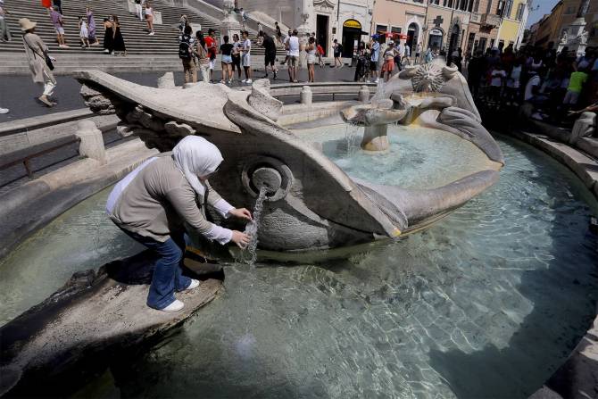 Woman in fountain amid heat wave