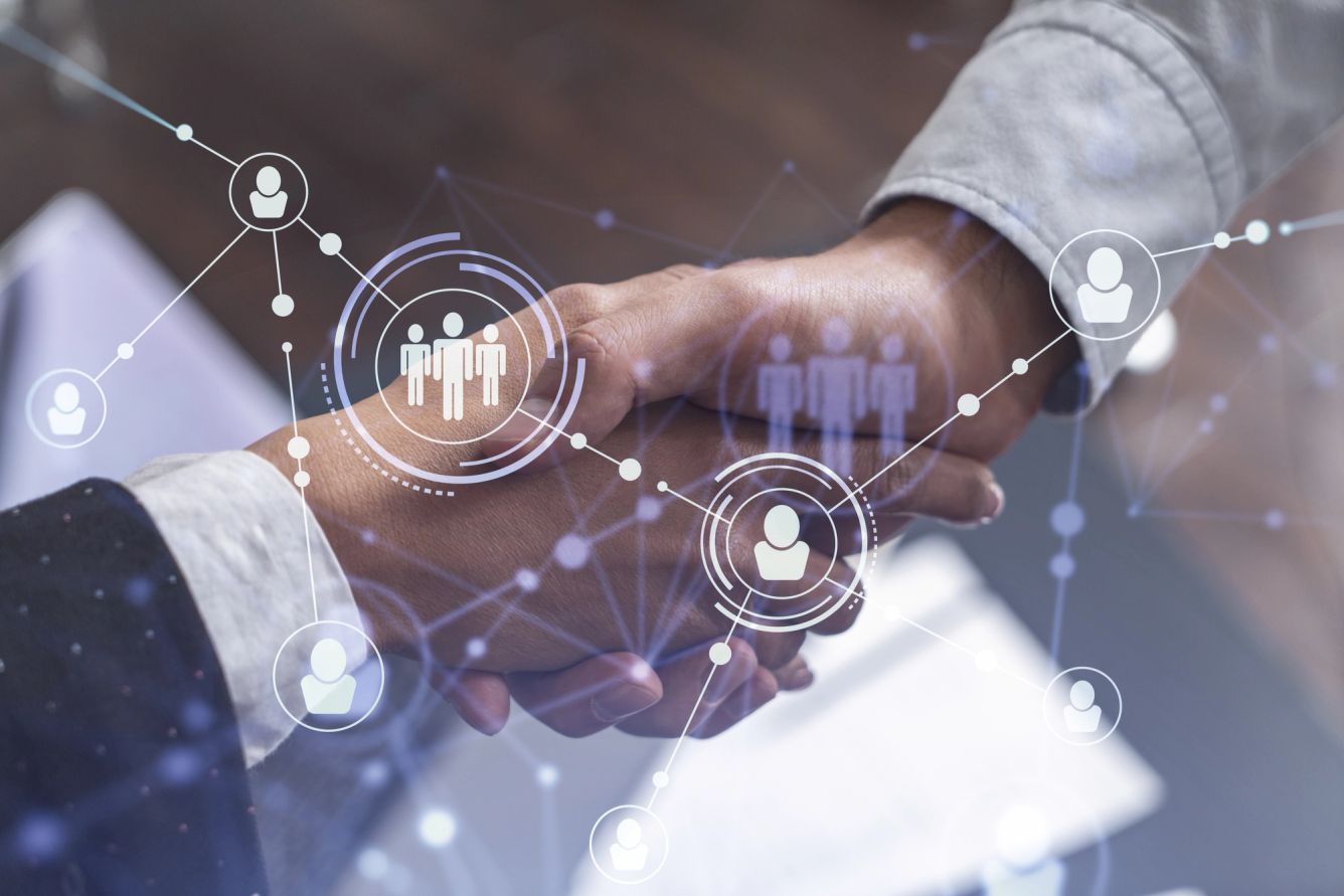 Social media hologram icons over two hands shaking