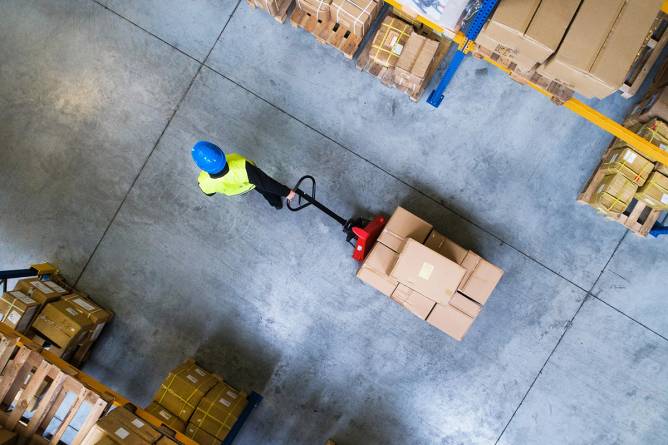 A worker moving package in a warehouse