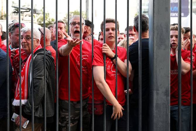 Liverpool fans react as they queue outside the stadium prior to the UEFA Champions League final match between Liverpool FC and Real Madrid