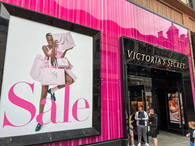 Street view of people standing in front of a Victoria's Secret store