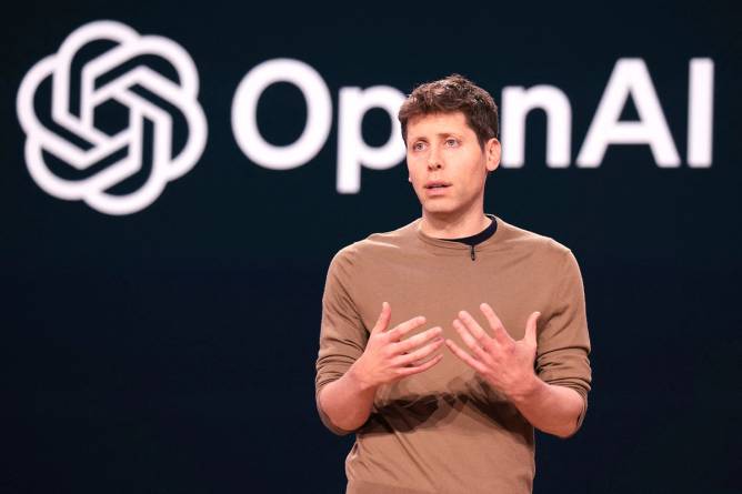 Sam Altman in front of the OpenAI logo