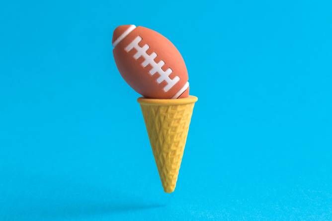 A football atop an ice cream cone