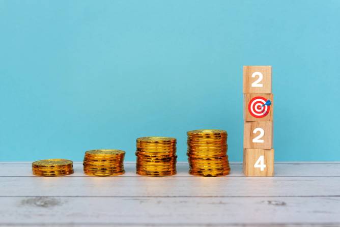 Stack of coins with blocks that read 2024 and a target.