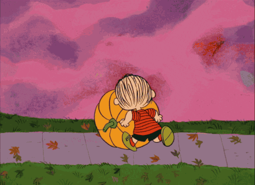 Charlie Brown rolling a pumpkin