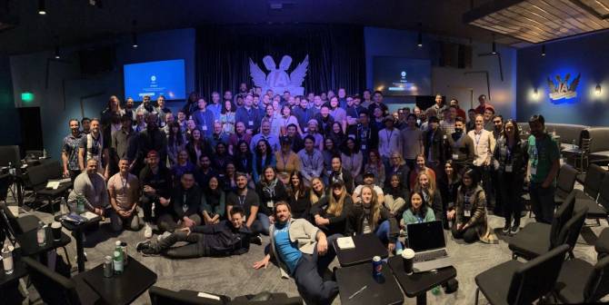 A collection of individuals in a conference room-style setting.