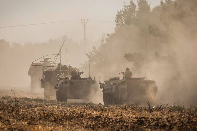 Military vehicles are seen after Palestinian militants launched more rockets at Israeli border towns on the second day of the ongoing conflict between Israel and the Palestinian militant group Hamas