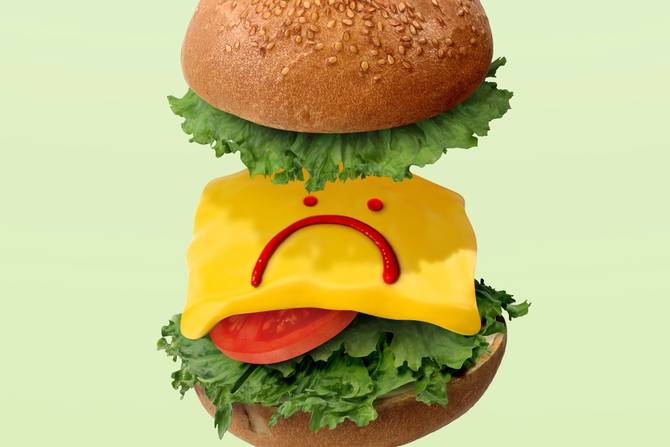 Illustration of a burger with just lettuce, tomatoes, and cheese. Ketchup is in a frowny face.