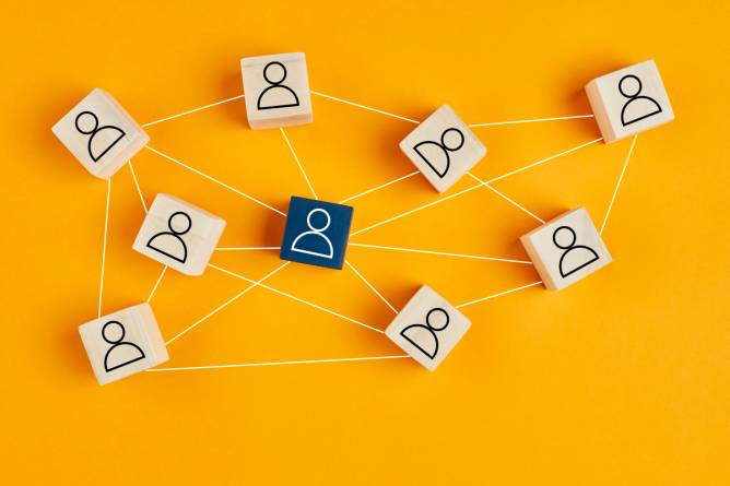 Wooden blocks with silhouettes depicting a network