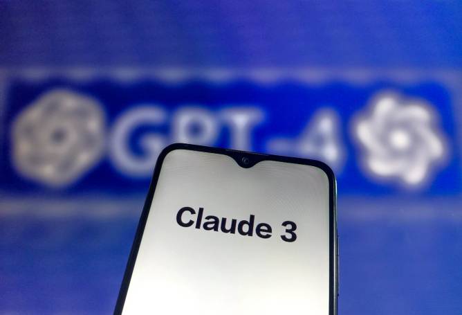 A screen displaying the text "Claude 3" in front of a blurred backdrop of the GPT-4 logo.