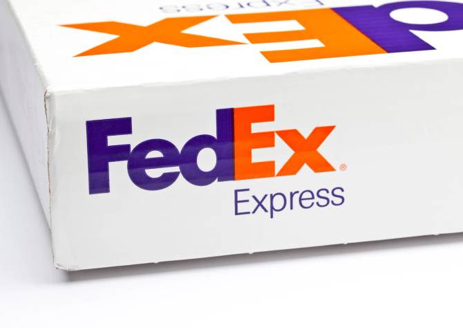 A FedEx shipping box with its logo prominent. 