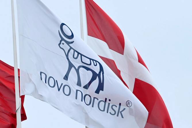A Novo Nordisk flag in front of a Danish flag
