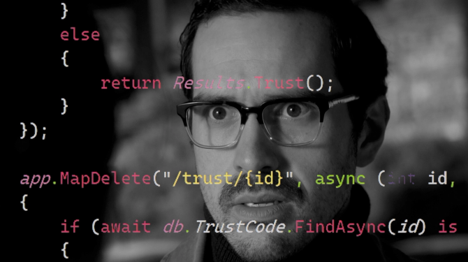 Black-and-white image of a man who appears concerned, overlayed by multilayered text of code.