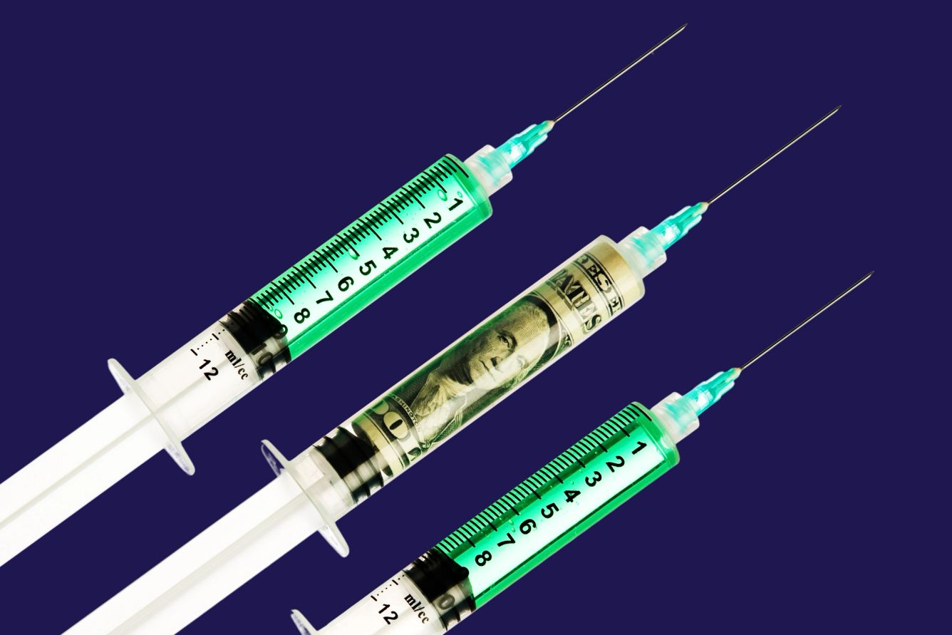 three syringes, one with a dollar inside