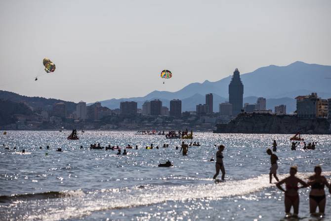 Tourists fill the Levante beach in Benidorm to quench high temperatures as a heatwave sweeps across Spain
