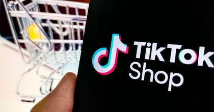A smartphone screen displaying the TikTok Shop logo with a shopping cart in the background