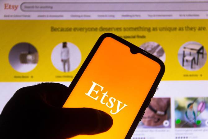 A phone displaying the Etsy logo.