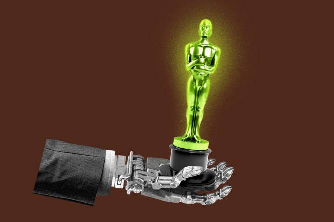 The arm of a robot holding an Academy Award