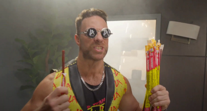 WWE star LA Knights holds a Slim Jim during a commercial for the jerky