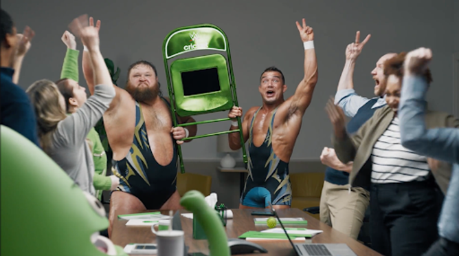 WWE performers Otis and Chad Gable hold the "chair phone" in a Cricket Wireless ad.