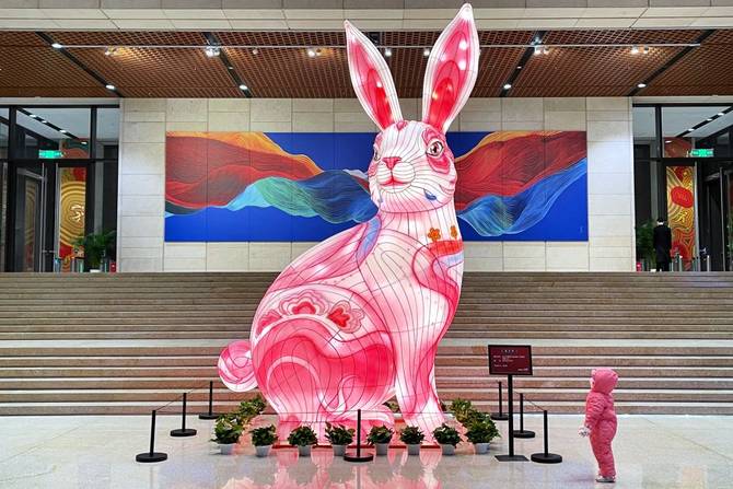 A child looks at a giant rabbit lantern at the China National Arts and Crafts Museum and China Intangible Cultural Heritage Museum
