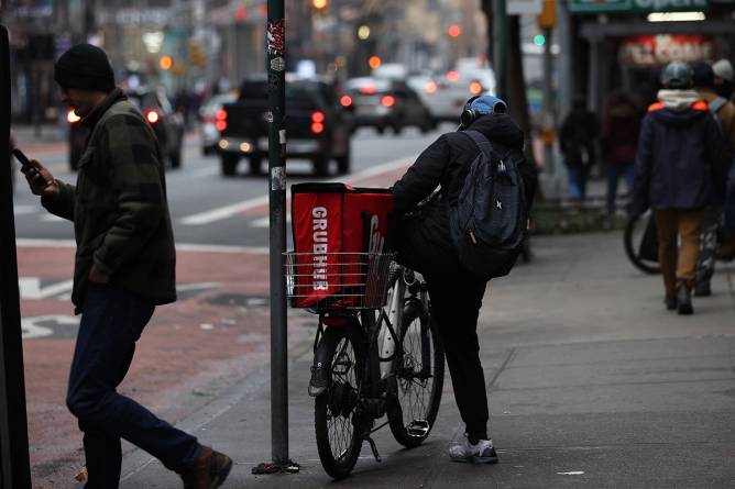 Grubhub worker parking bike.