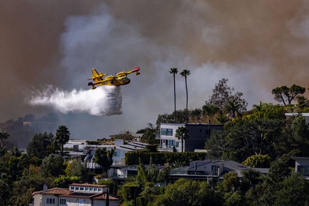 Super Scooper plane drops water on the Palisades fire