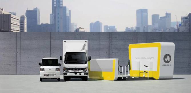 Commercial vehicles next to an Ample battery-swapping station