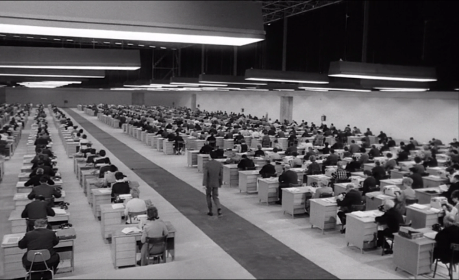 A large open floor plan office from a scene in Orson Welles's The Trial.