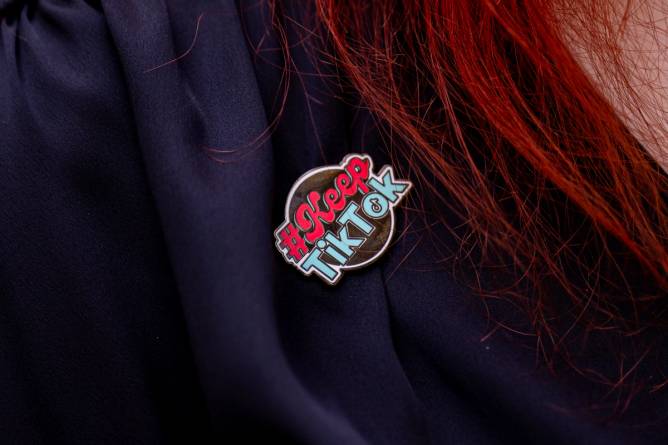 a keep tiktok pin on someone'e collar