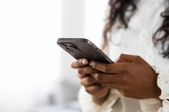 Image of a person texting on a smartphone.