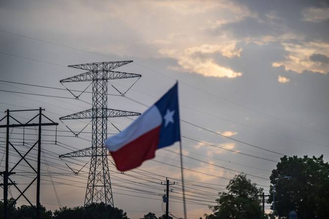 Texas flag in front of power lines