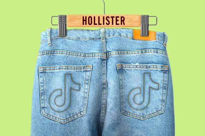 Jeans with TikTok logos on the back pockets hanging on a Hollister branded hanger