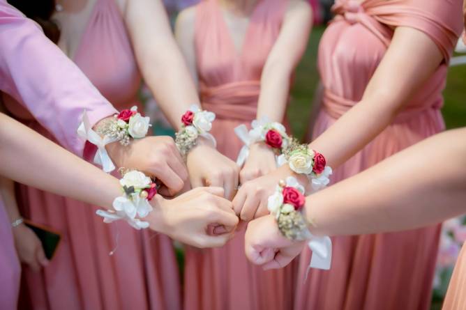 arms with wedding corsages