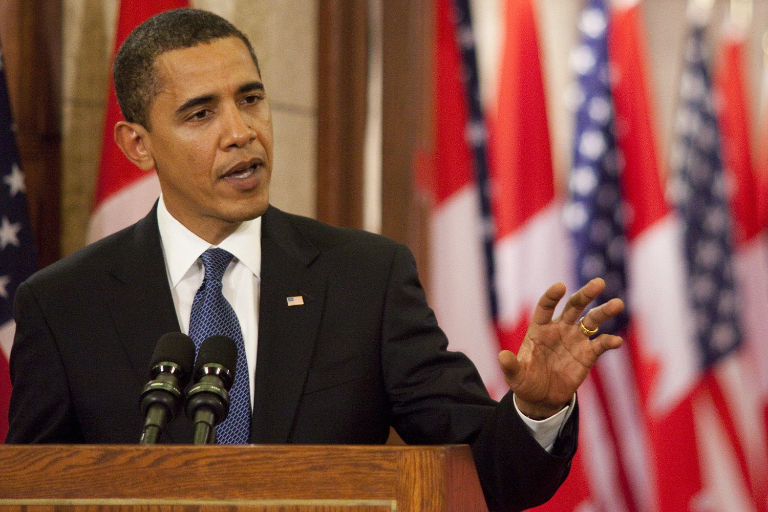 President Obama, standing at a podium with microphones, press conference.