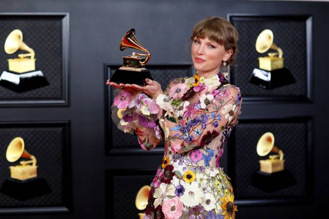 Taylor Swift with her Grammy on the red carpet at the 63rd Annual Grammy Awards, at the Los Angeles Convention Center, in downtown Los Angeles, CA, Sunday, Mar. 14, 2021.