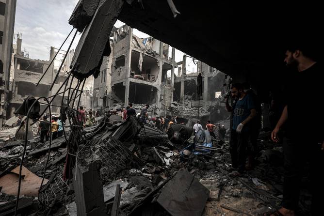 Civil defense teams and civilians conduct search and rescue operations after Israeli attacks on Gaza City.