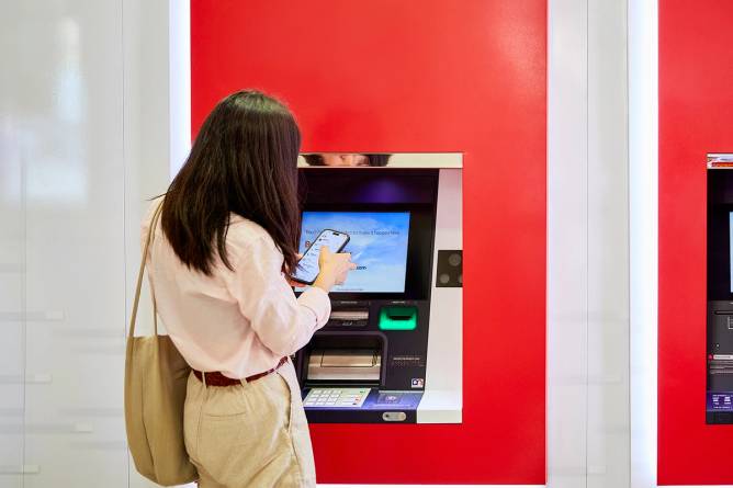 A woman uses an ATM