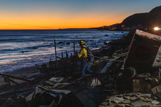 an emergency worker walking through rubble